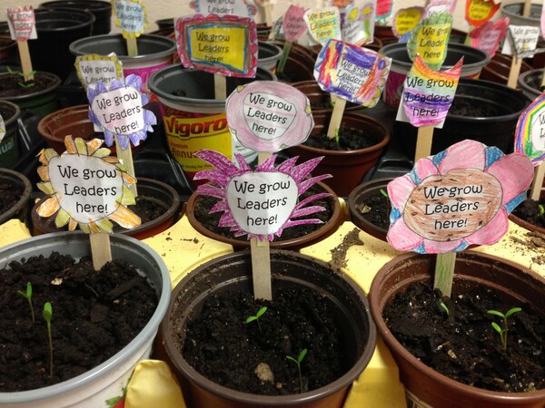 flower pots that say "we grow leaders here"