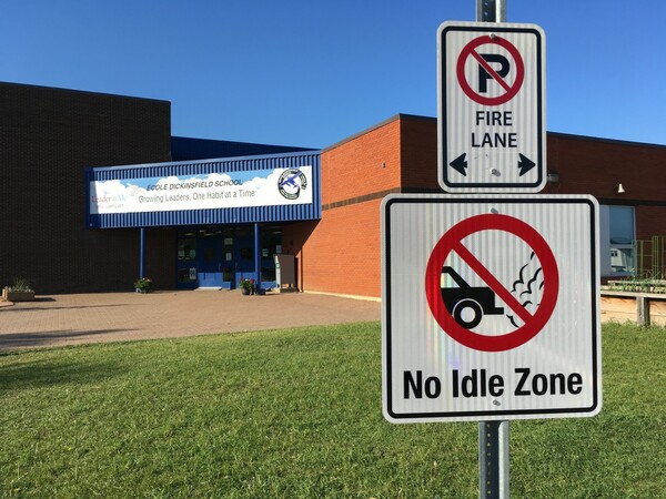 school building with "no idle zone" sign